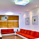 Waiting room with ceiling spot lights and central larger lights plus
window blinds to block sunrays